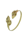 WILDSIDE gold leaf cuff bracelet with realistic botanical motifs on a textured brown background