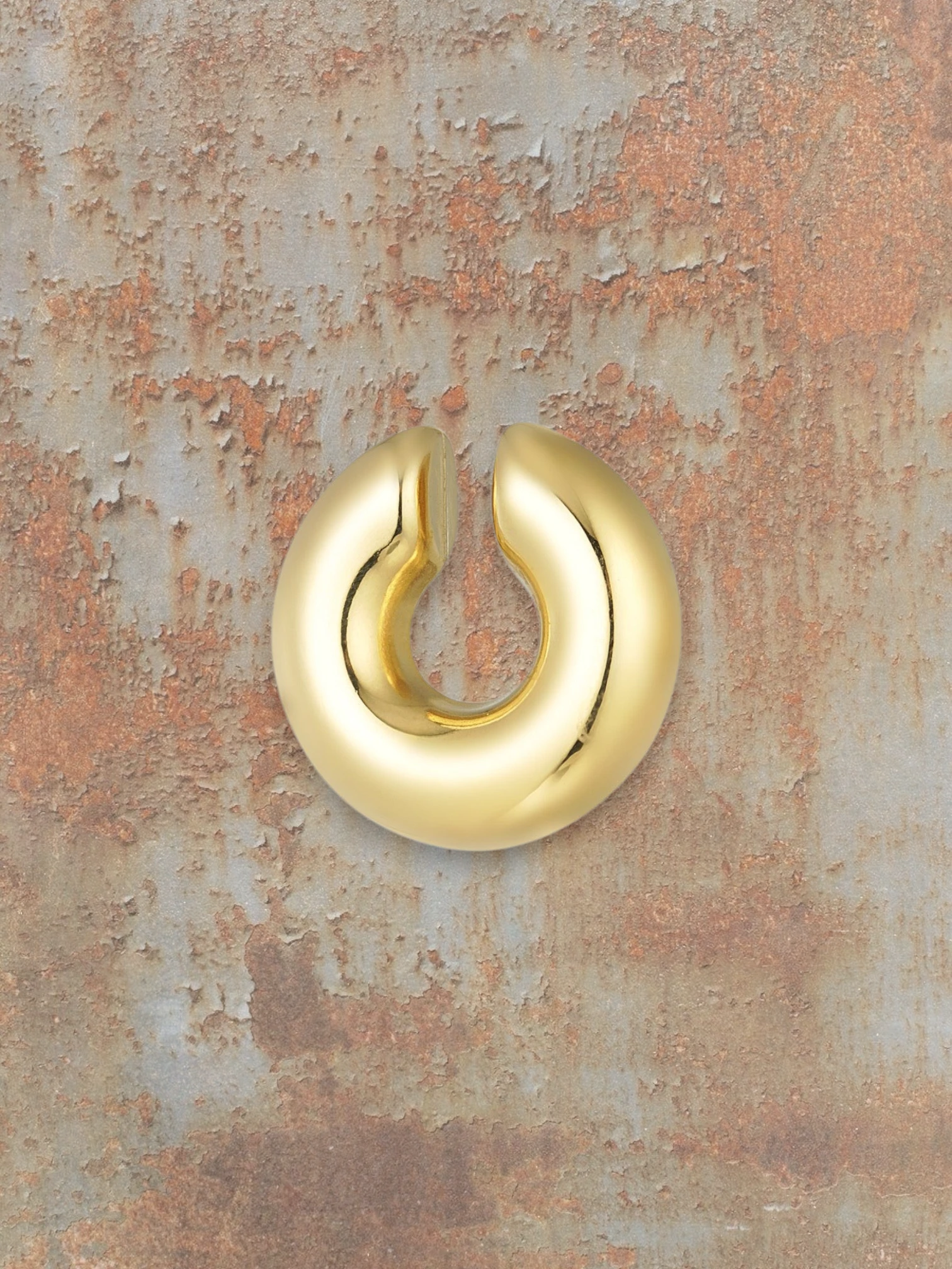 WILDSIDE gold statement ear cuff, a bold, polished metal accessory that slides onto the ear without piercing.
