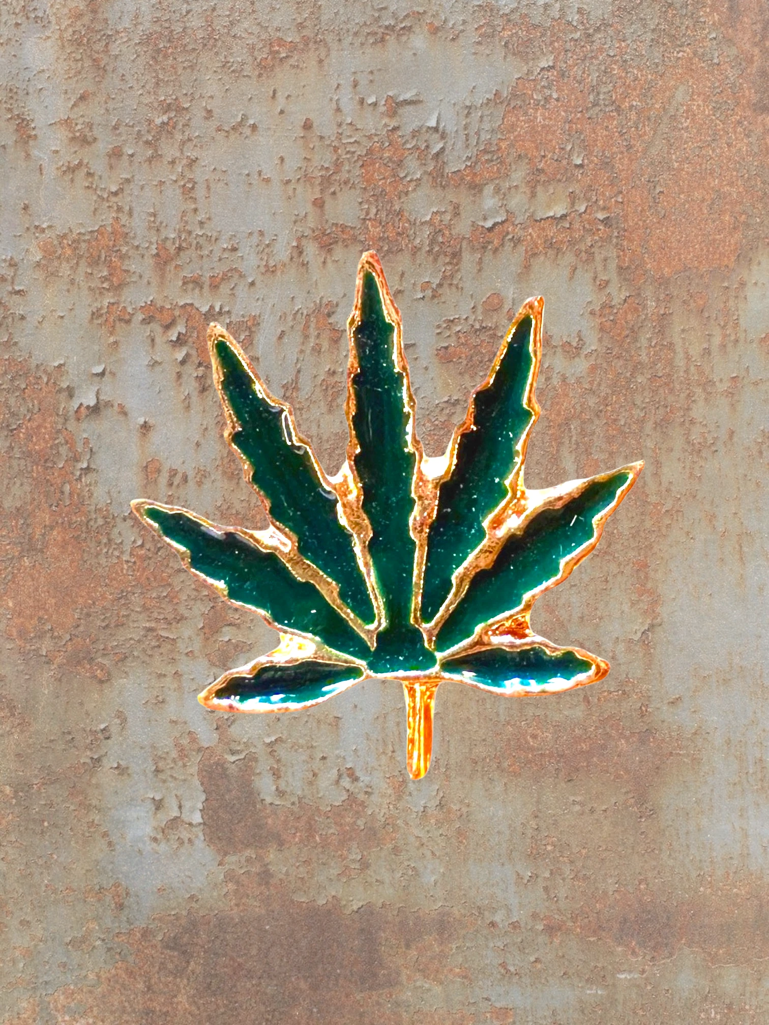 WILDSIDE green enamel marijuana leaf pin with gold trim, perfect for jackets and bags.