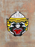 WILDSIDE mask pin featuring a fierce Hanuman face with white, gold, green, and red enamel details.