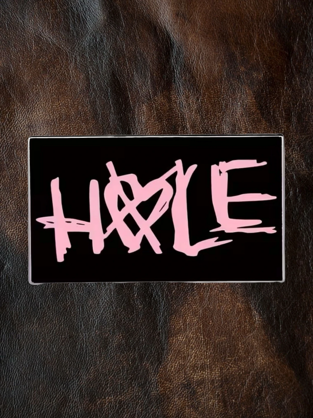 WILDSIDE black rectangular pin with pink 'Hole' band logo and heart detail.
