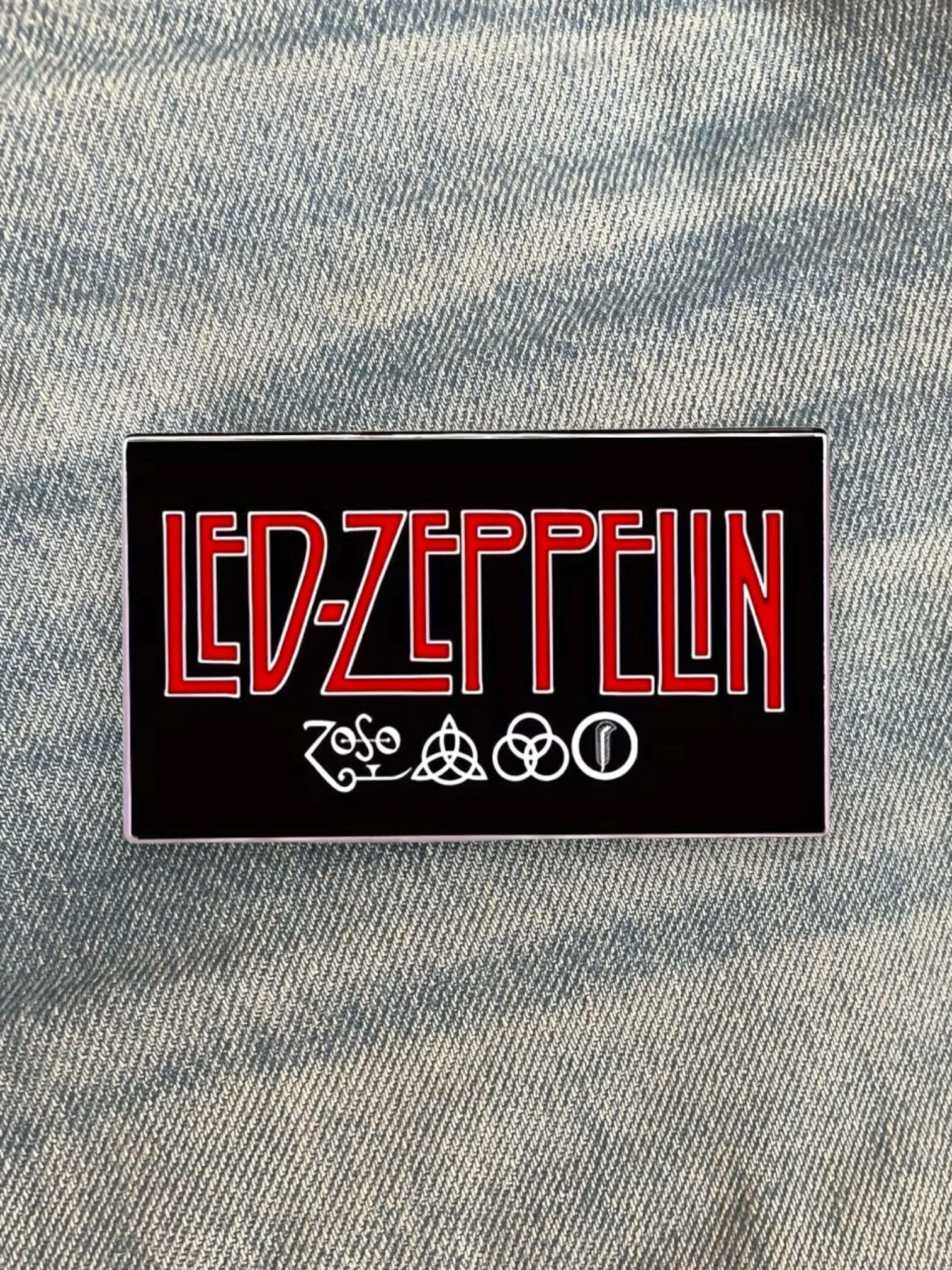 WILDSIDE Led Zeppelin rectangular pin with red lettering and four symbols on a black background.