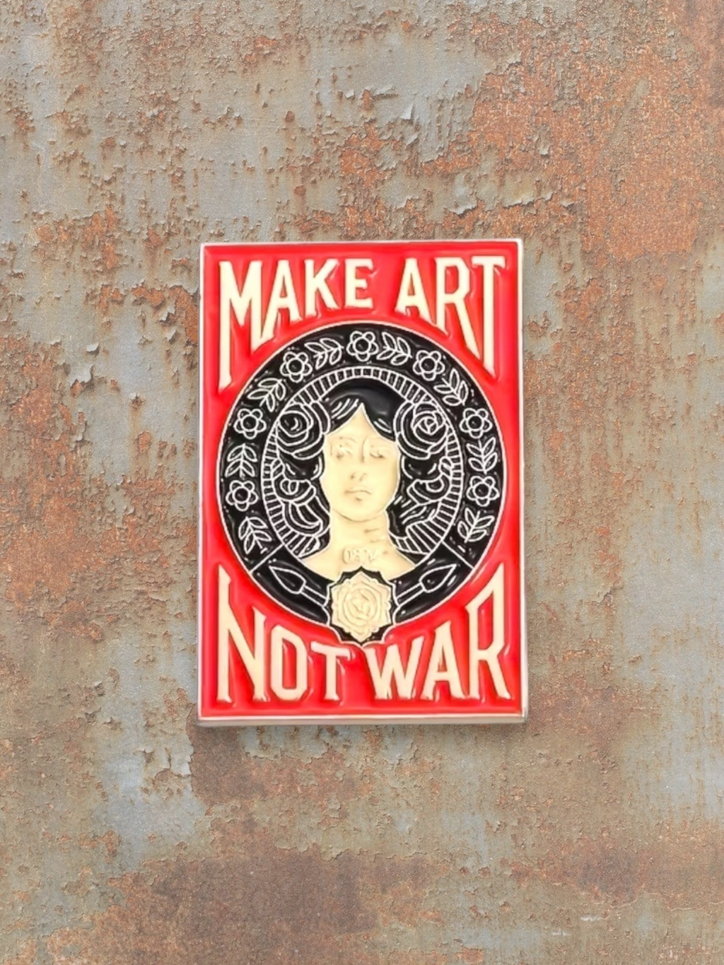 WILDSIDE Make Art Not War enamel pin with a portrait of a woman surrounded by floral elements.