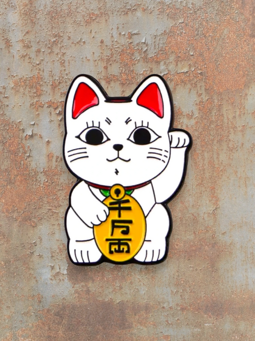 WILDSIDE white enamel Maneki Neko cat pin with red ears and a gold coin.
