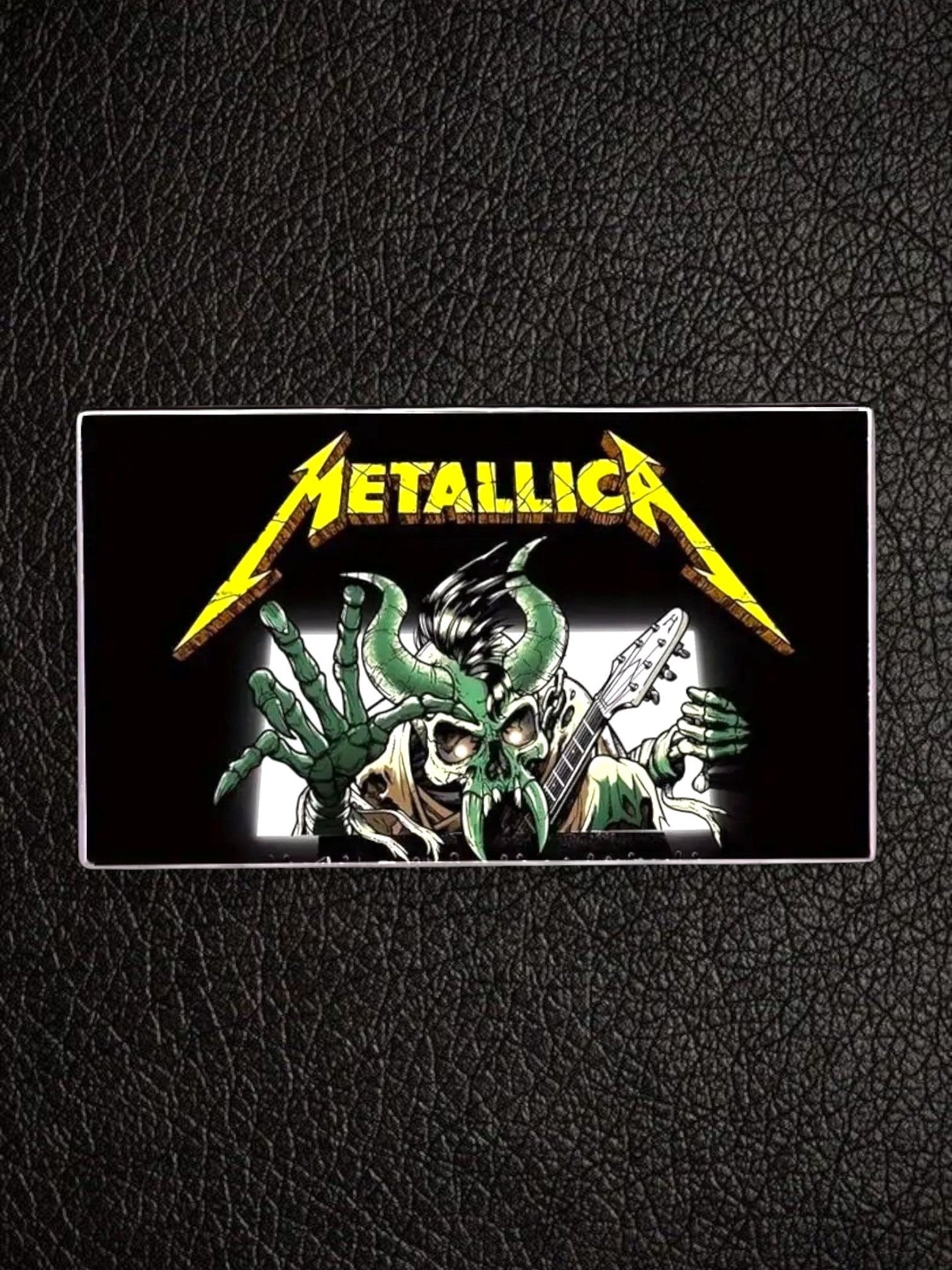 WILDSIDE Metallica band logo pin featuring a green skeletal monster playing a guitar. Black background.