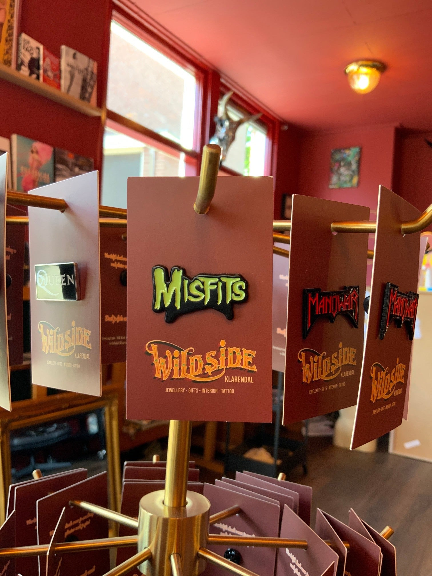 WILDSIDE Misfits enamel pin with green lettering and black outline on a brown card.