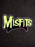 WILDSIDE Misfits logo pin with neon green lettering on a black background.
