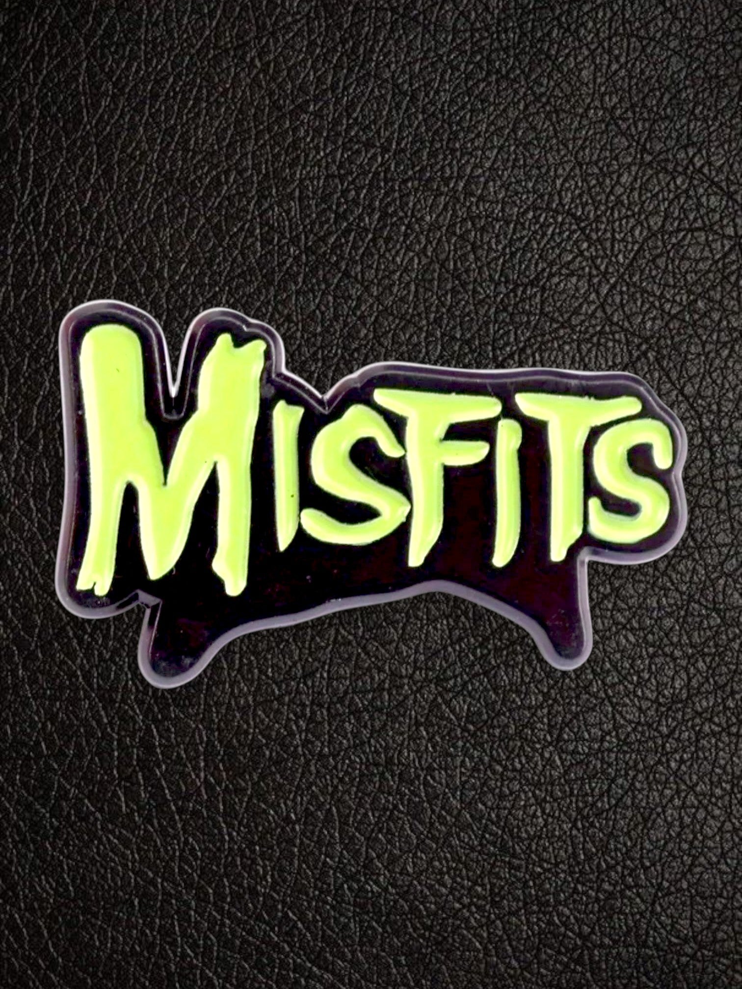 WILDSIDE Misfits logo pin with neon green lettering on a black background.