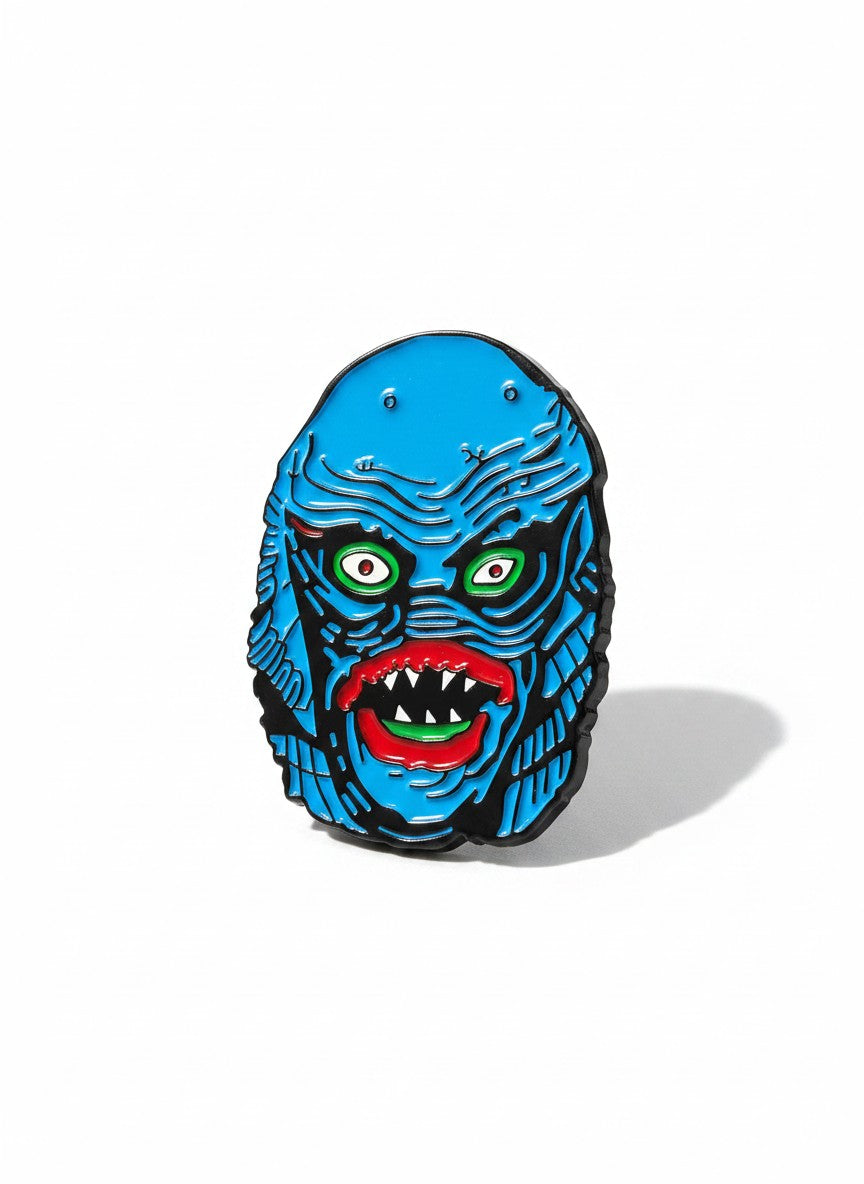 WILDSIDE blue monster pin with green eyes and sharp teeth, perfect for jackets and bags.