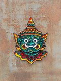 WILDSIDE enamel pin featuring a green mythical creature mask with a red and yellow headdress and ornate details.