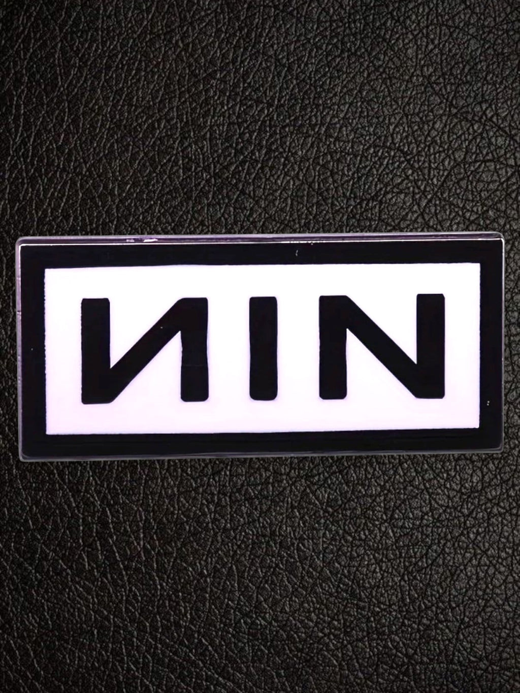 WILDSIDE Nine Inch Nails NIN logo pin, black text on white background, rectangular shape.