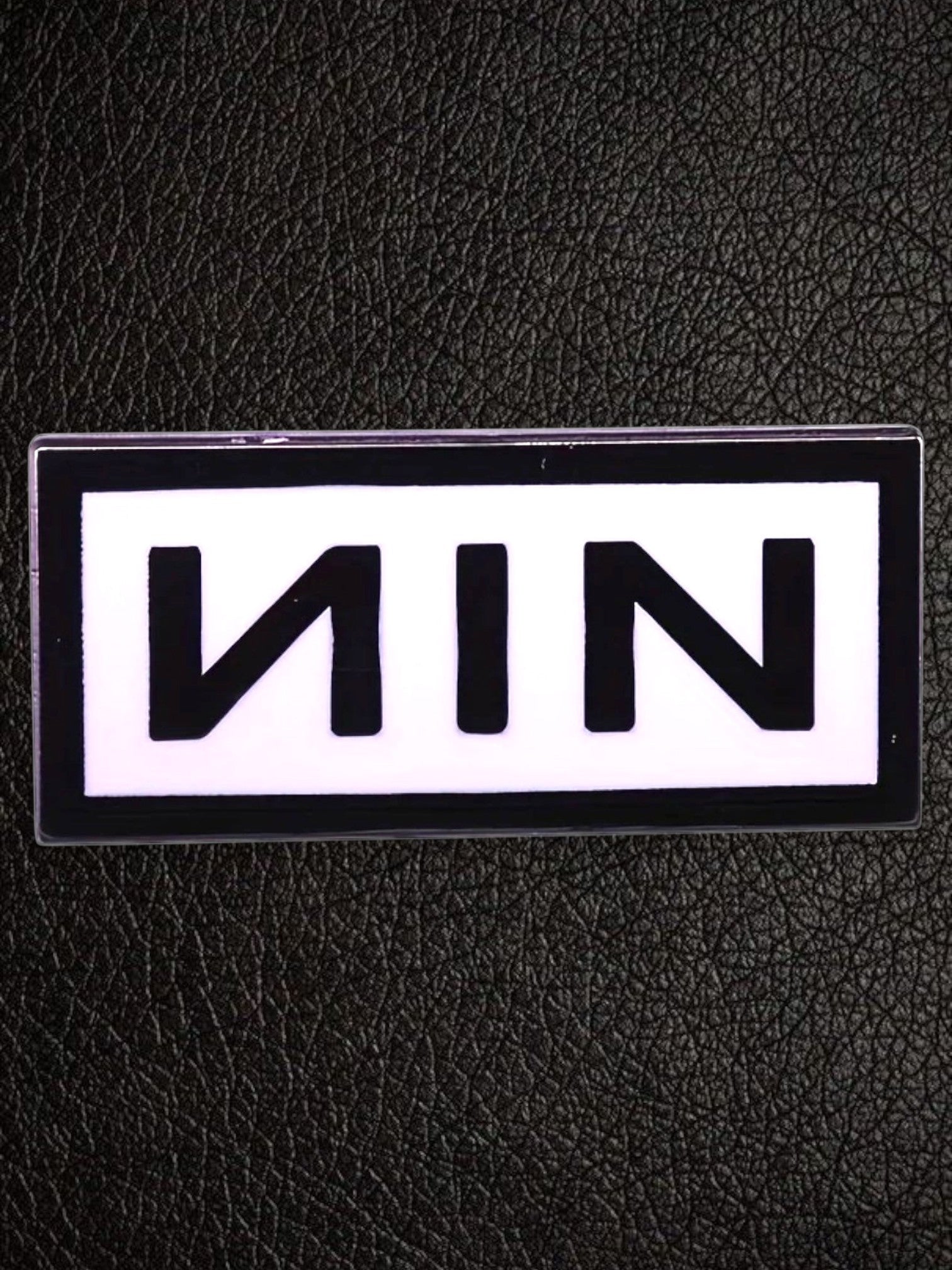 WILDSIDE Nine Inch Nails NIN logo pin, black text on white background, rectangular shape.
