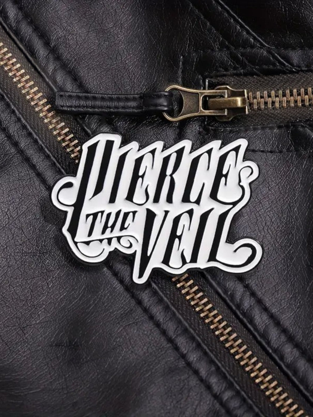 WILDSIDE Pierce the Veil band logo pin on a black faux leather jacket with zipper detail.