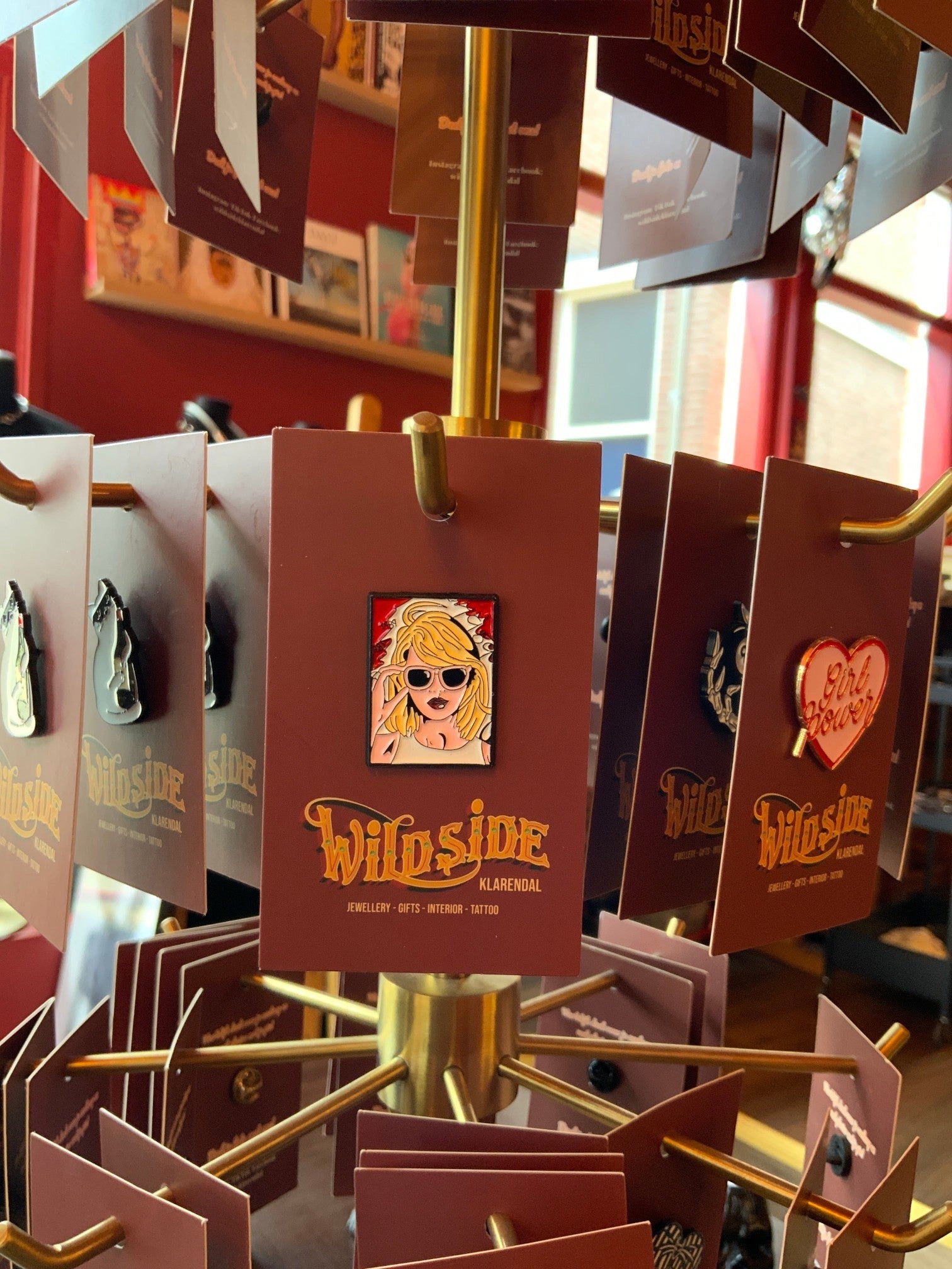 WILDSIDE enamel pin featuring a blonde woman with sunglasses and red lipstick, styled in a pop art aesthetic.
