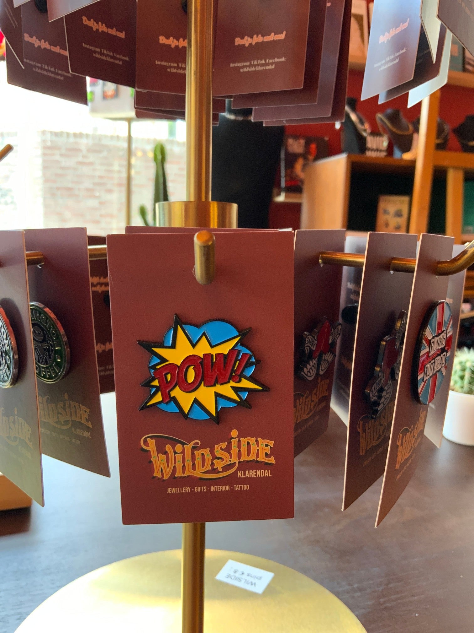 WILDSIDE PopArt POW enamel pin with yellow and blue comic book style explosion graphic.