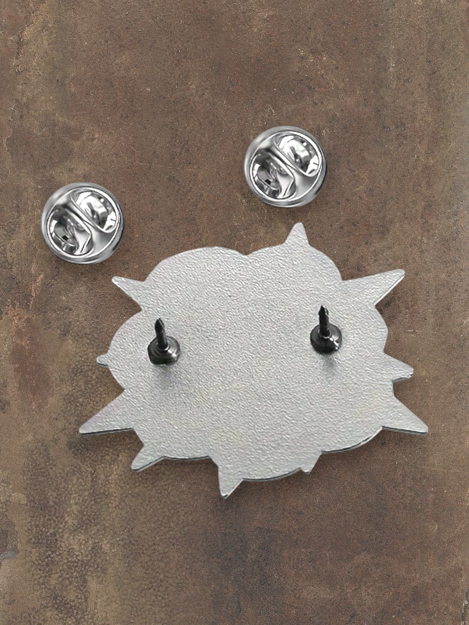 WILDSIDE PopArt POW enamel pin with two metal clasps on the back, silver and black.
