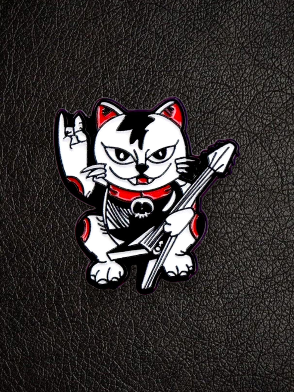 WILDSIDE punk cat pin with guitar and rock on hand gesture, black, white, and red enamel.