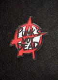 WILDSIDE red and black enamel pin with anarchy symbol and "Punk's Not Dead" text.