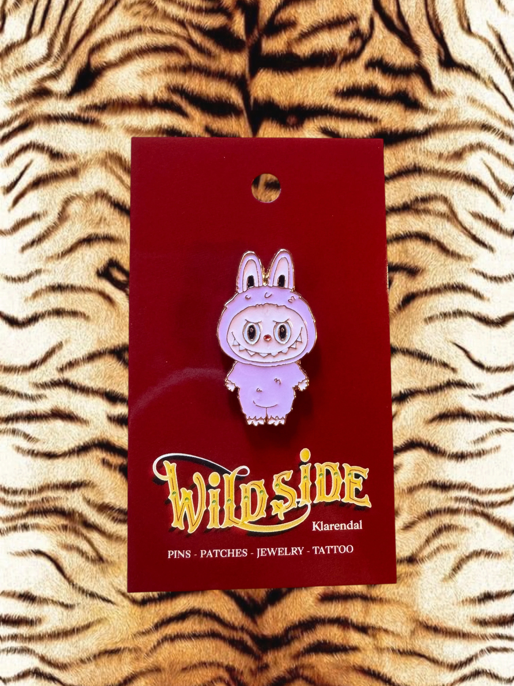WILDSIDE purple cartoon bunny enamel pin with angry expression and fuzzy trim.