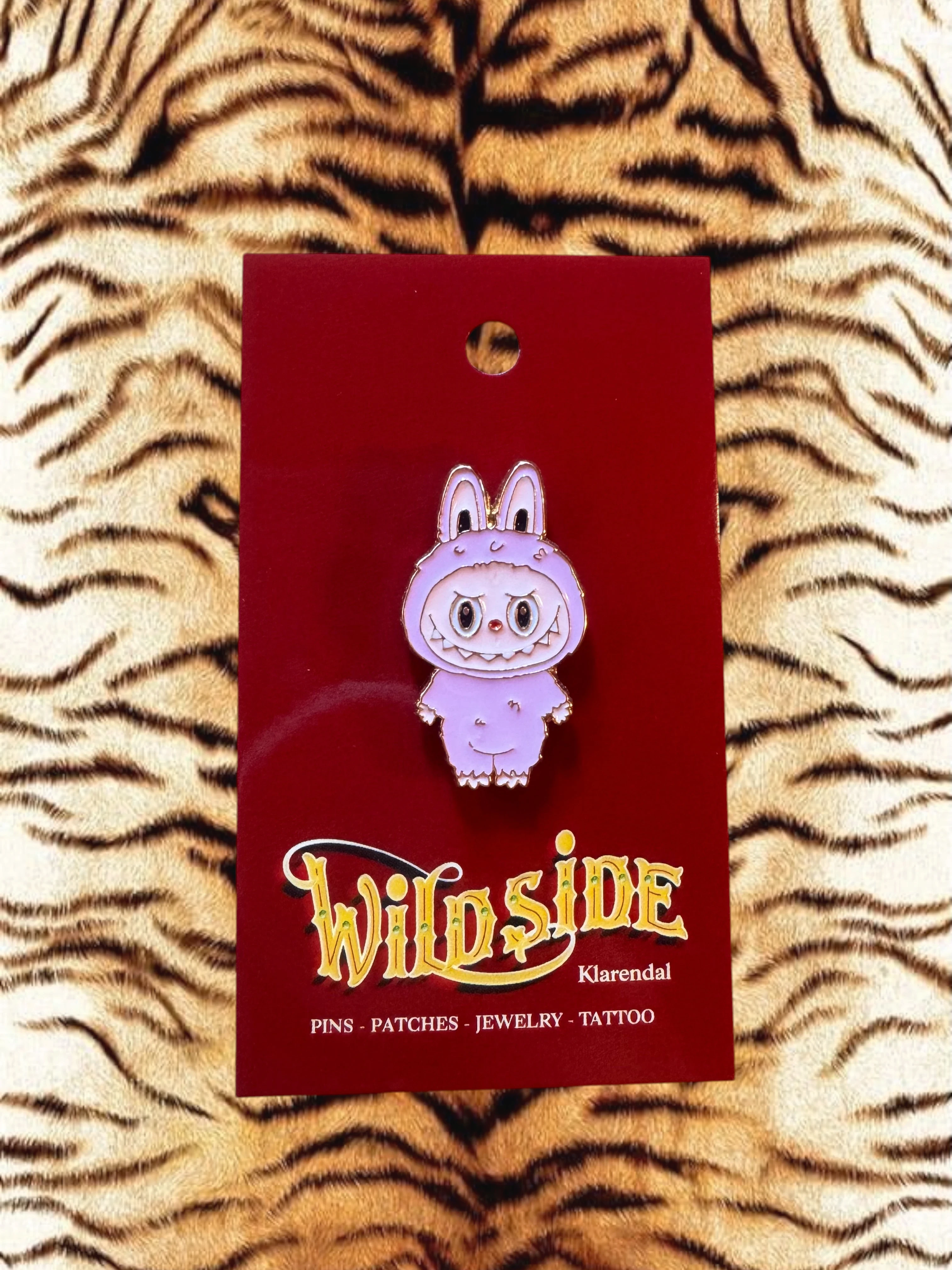 WILDSIDE purple cartoon bunny enamel pin with angry expression and fuzzy trim.