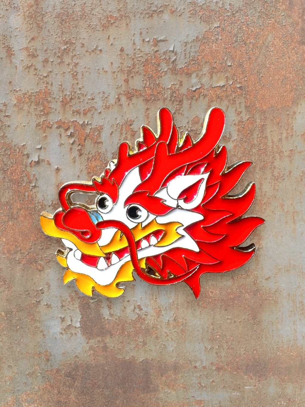 WILDSIDE red and yellow enamel dragon head pin with gold trim. Features intricate details and a fierce expression.