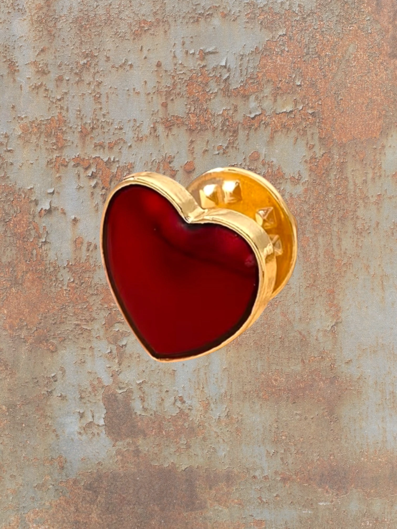 WILDSIDE gold-tone heart pin with a deep red enamel inlay. Perfect for adding a personal touch to jackets.