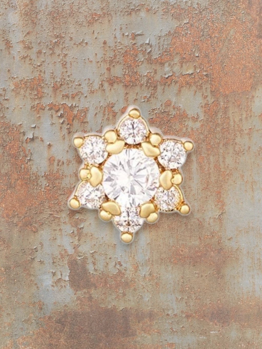 WILDSIDE silver stud piercing with clear cubic zirconia stones in a floral design.