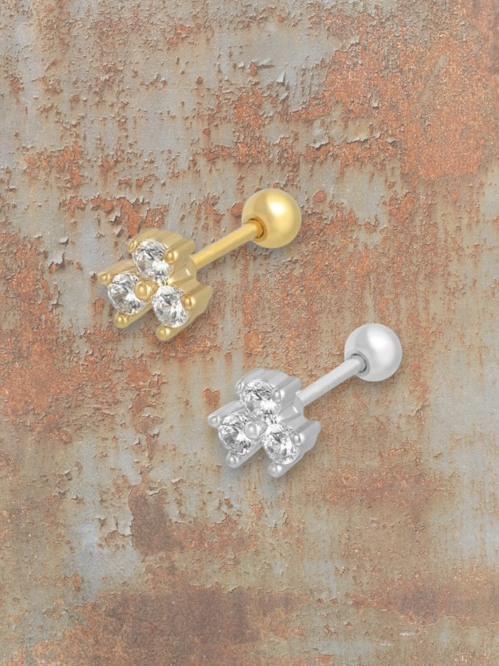 WILDSIDE silver labret piercing with three clear cubic zirconia stones in a clover design.