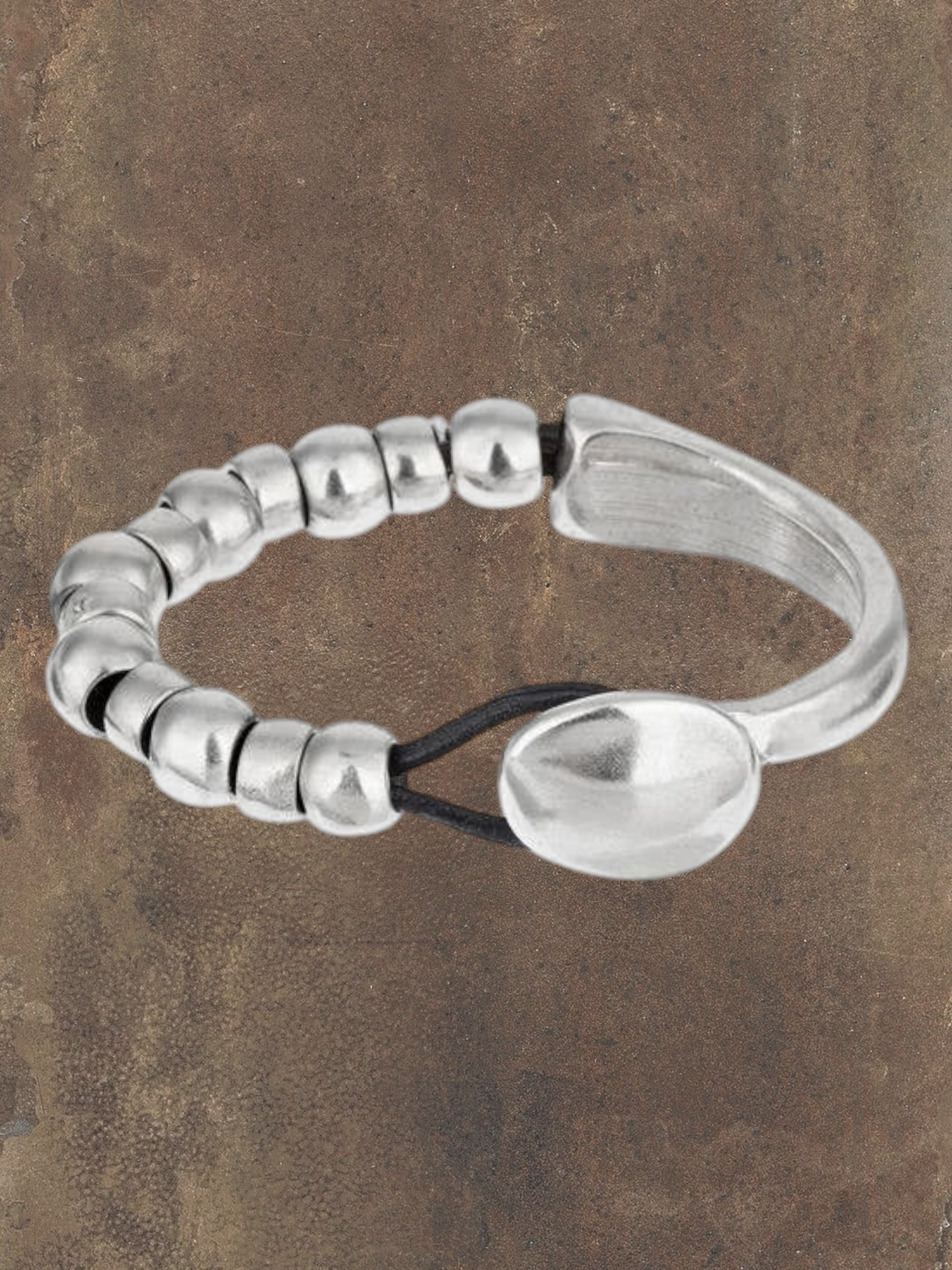 WILDSIDE "Unic" silver plated zamak and black leather bracelet with button clasp, approx 18cm.