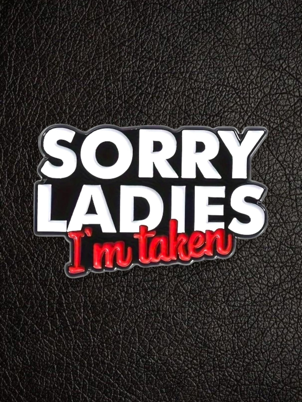 WILDSIDE "Sorry Ladies I'm Taken" enamel pin with white and red text on a black background.