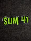 WILDSIDE Sum 41 logo pin in black with bright green lettering. Enamel pin.