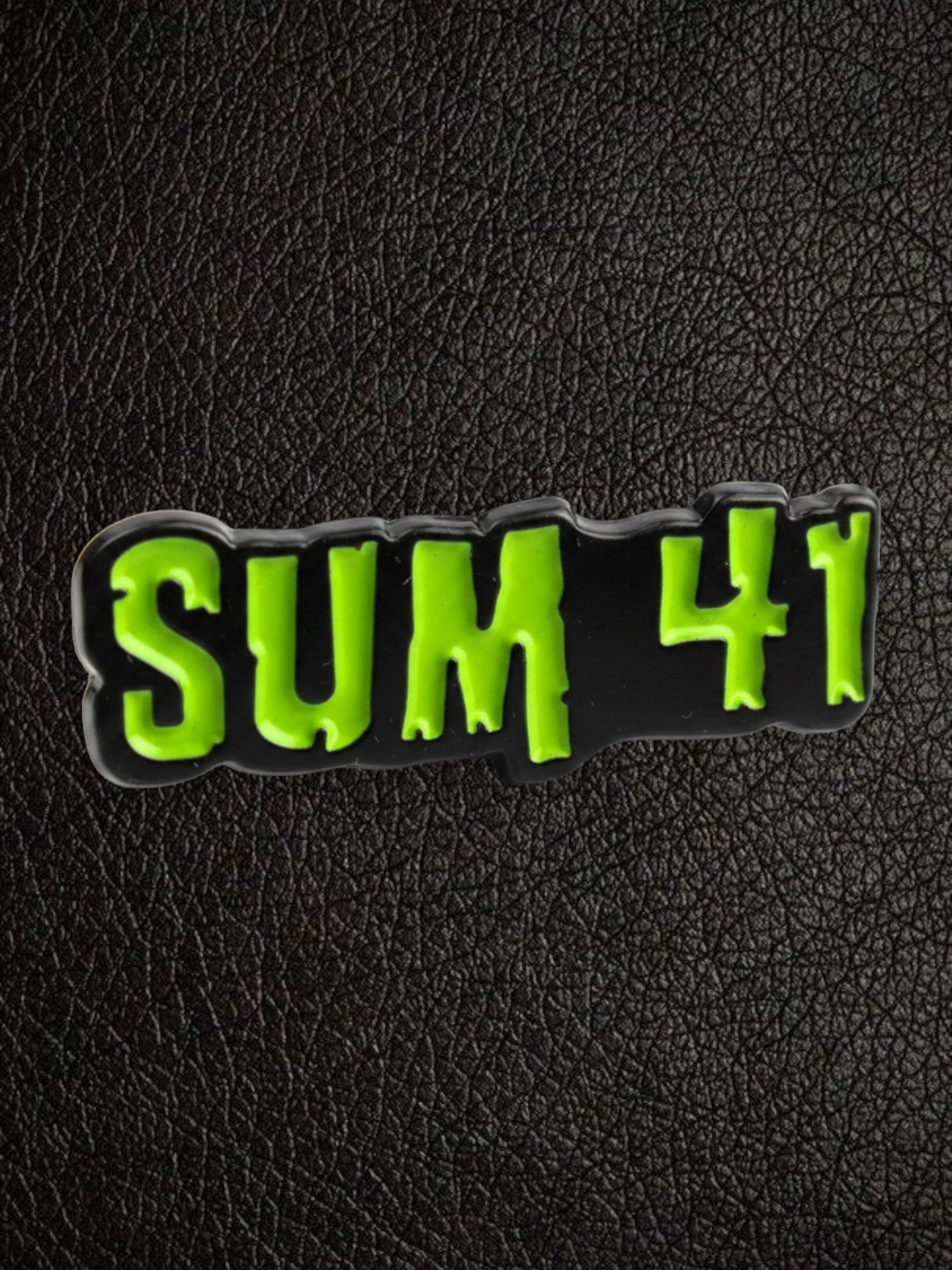 WILDSIDE Sum 41 logo pin in black with bright green lettering. Enamel pin.