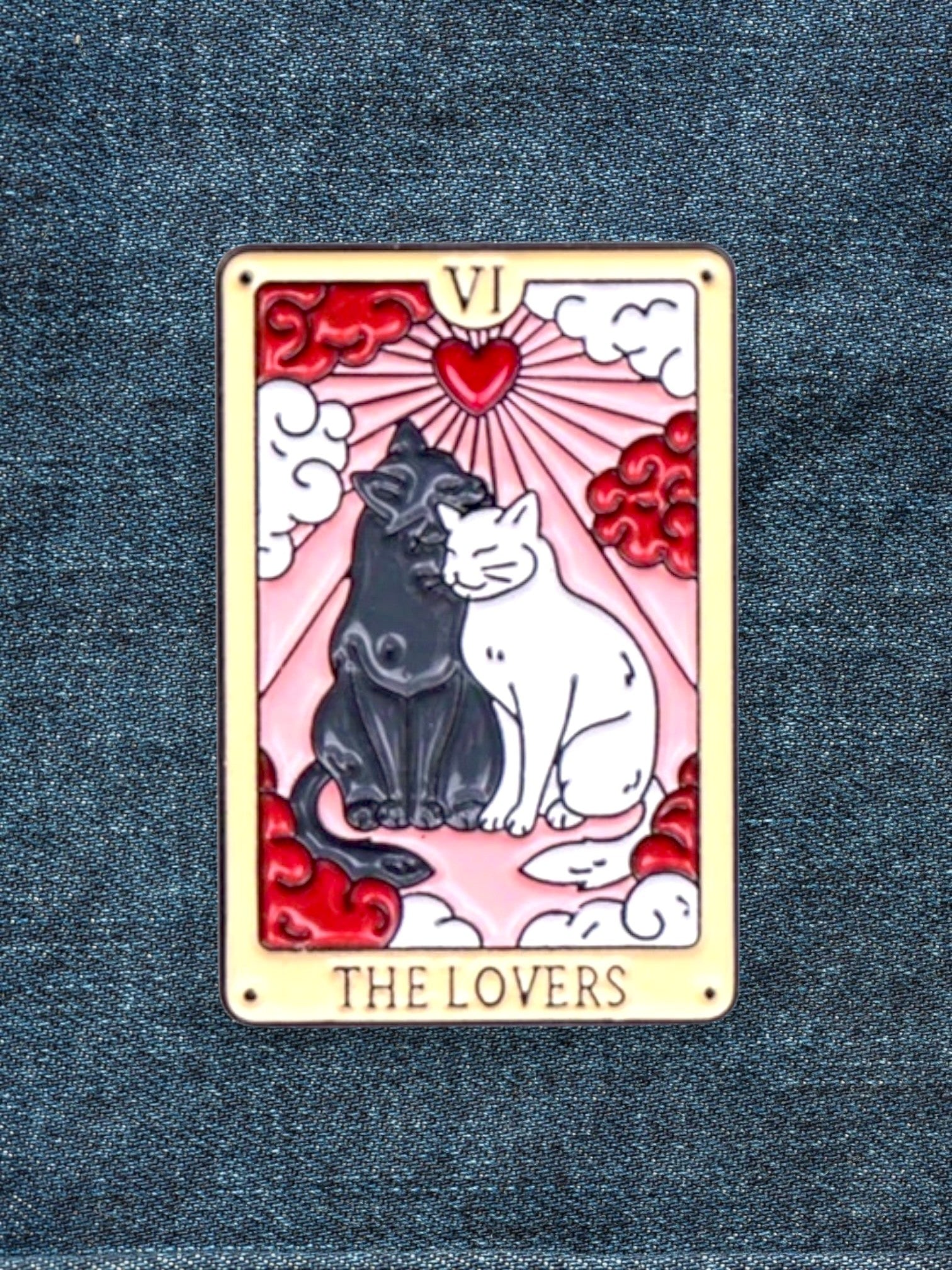 WILDSIDE Tarot The Lovers enamel pin featuring two cats, one black and one white, embracing with a heart and rays behind them.