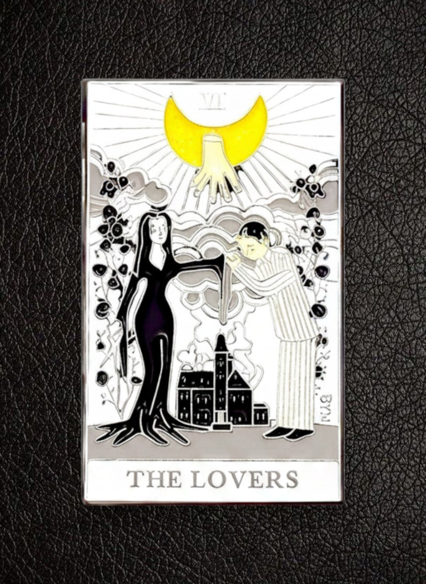 WILDSIDE Tarot the Lovers enamel pin, featuring a black and white illustration with yellow accents, depicting two figures under a crescent moon.