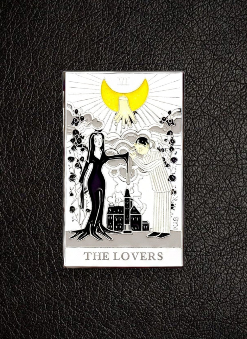 WILDSIDE Tarot The Lovers enamel pin featuring a black-clad figure and a striped-clad figure under a yellow crescent moon.