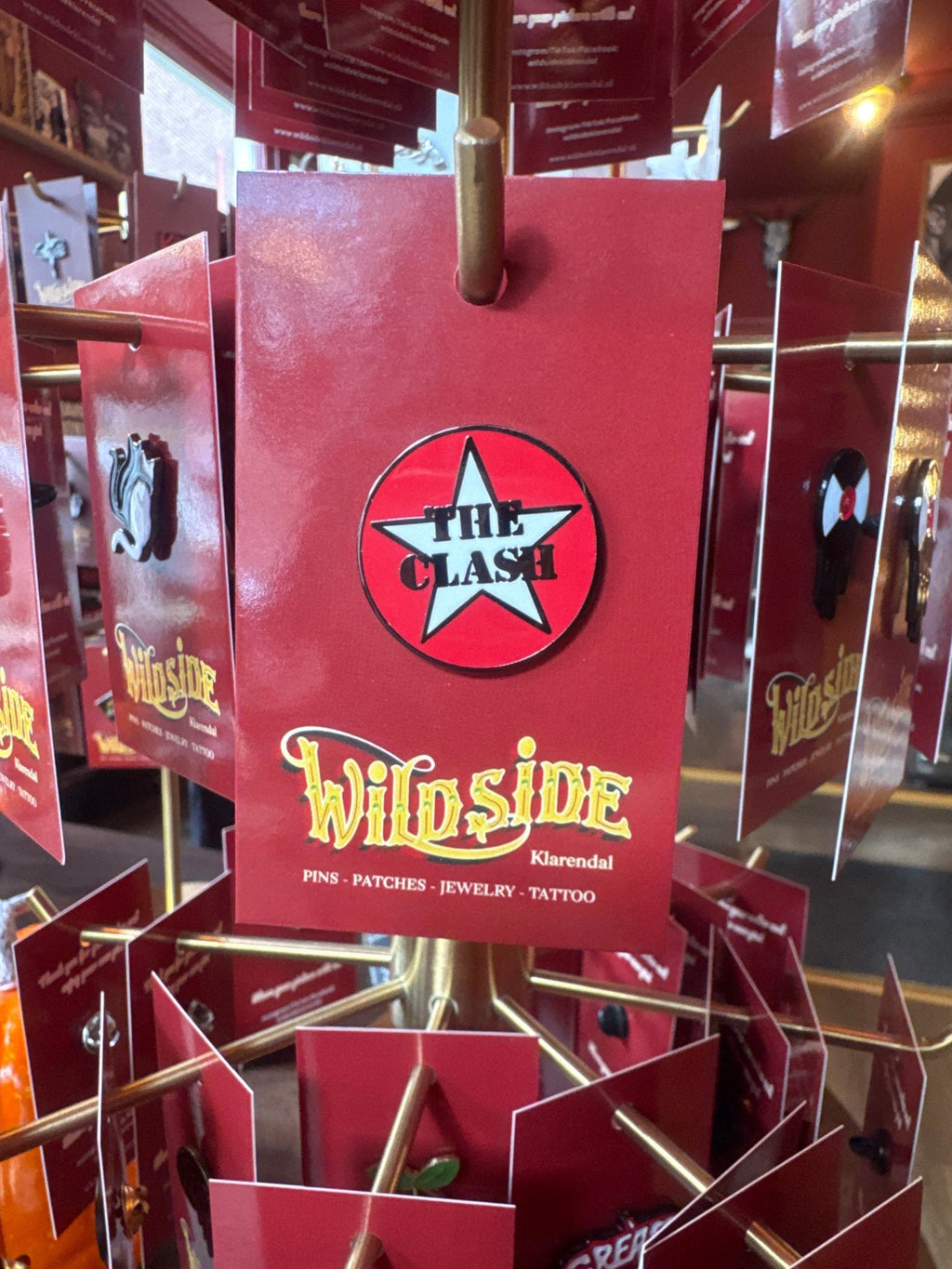 WILDSIDE The Clash star logo enamel pin. Red, white, and black design.