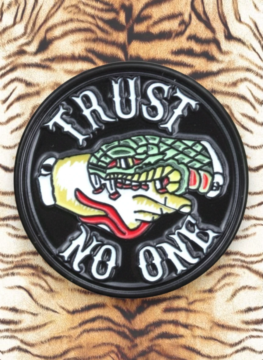 WILDSIDE Trust No One pin featuring a hand holding a snake, with text around the edge.