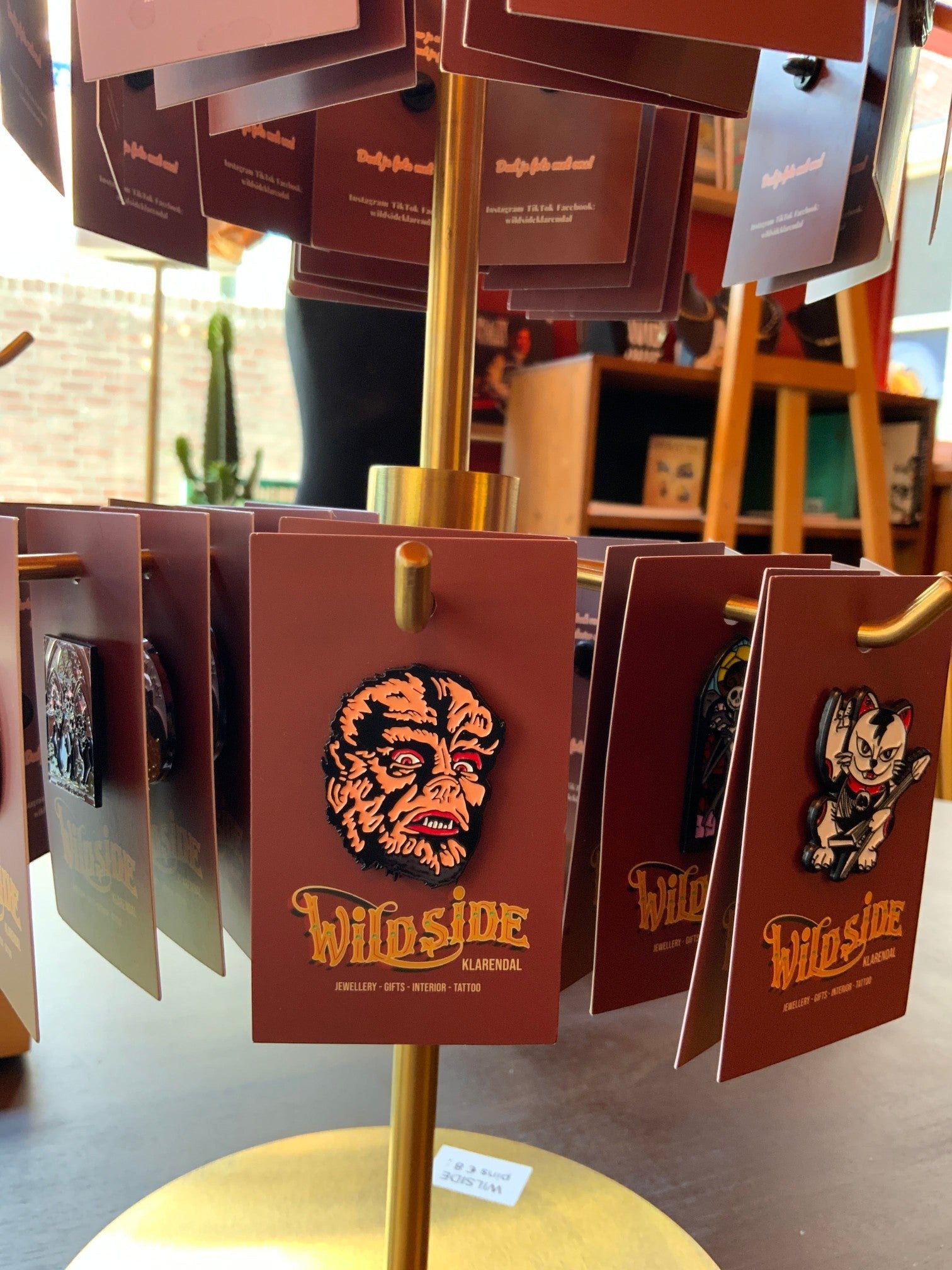 WILDSIDE Werewolf Face Enamel Pin with orange fur, red eyes, and fangs. Horror monster accessory.