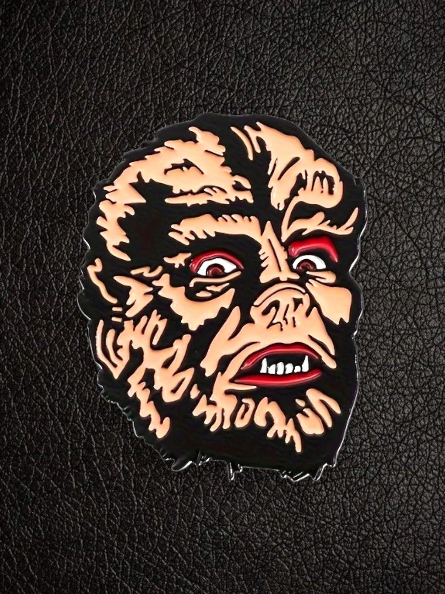 WILDSIDE Werewolf Face Enamel Pin with black, red, and tan details. Horror accessory.