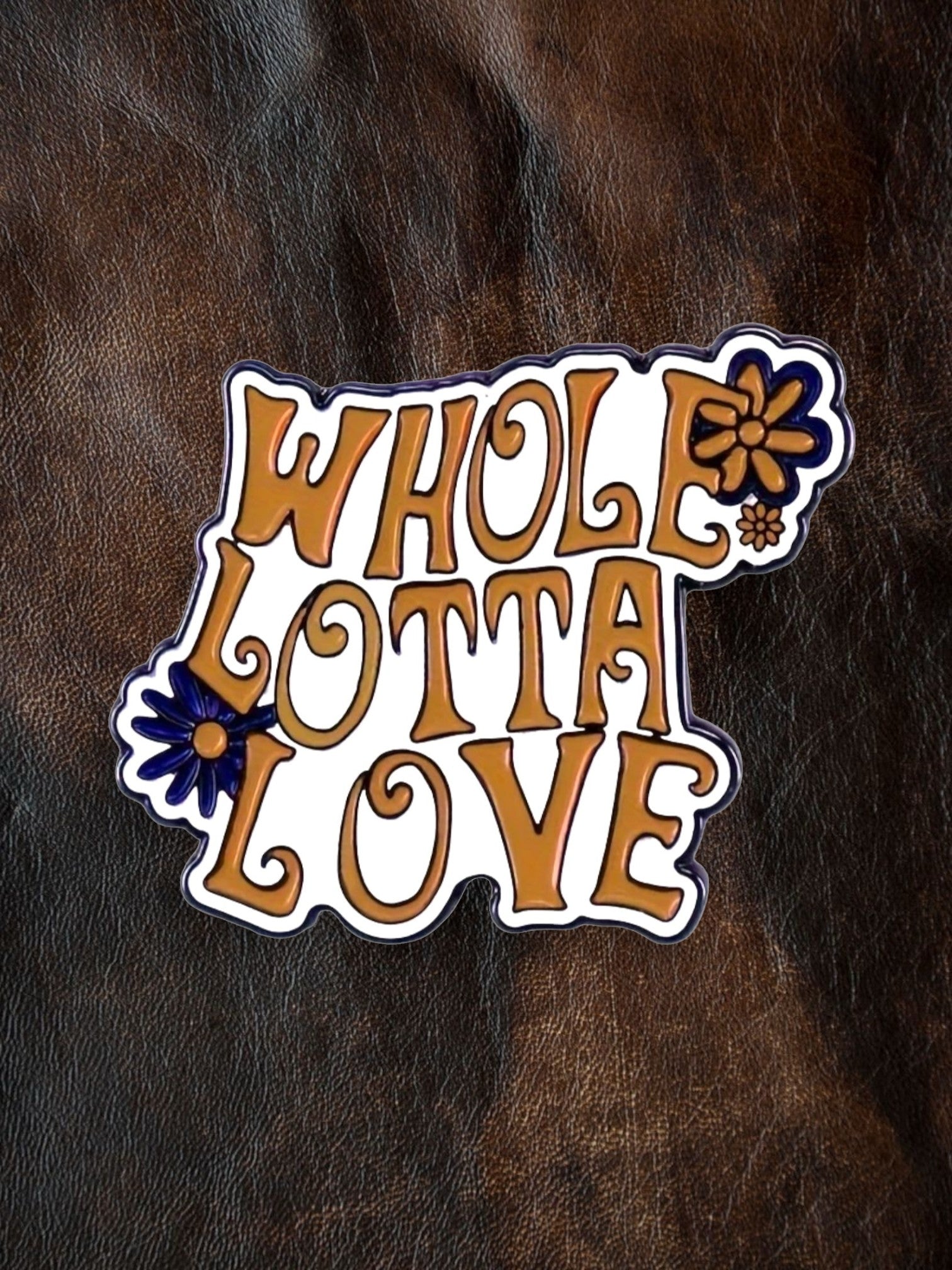 WILDSIDE Whole Lotta Love enamel pin with orange lettering and blue floral accents.